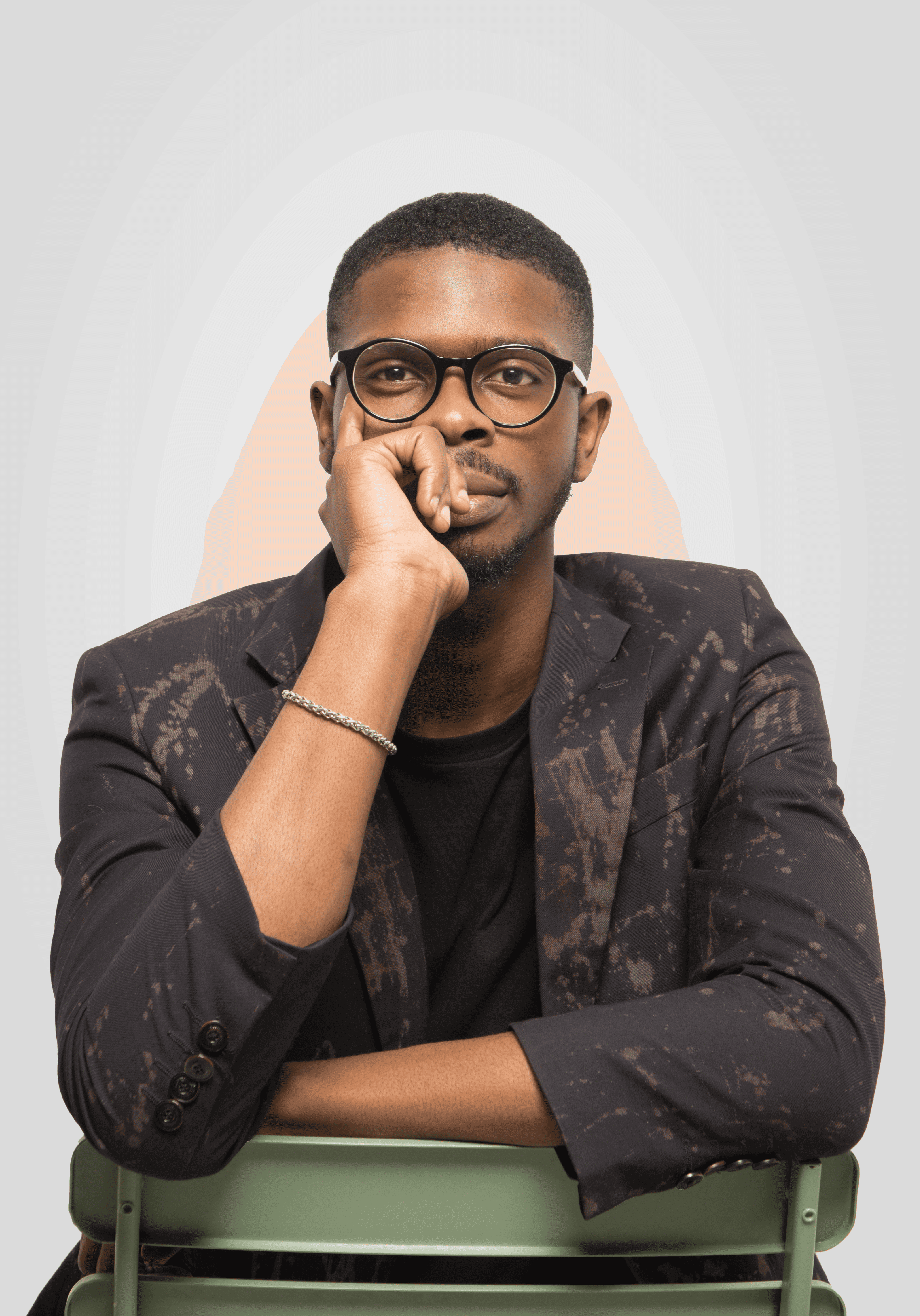 Portrait of a man wearing glasses and a light blue shirt, smiling slightly.